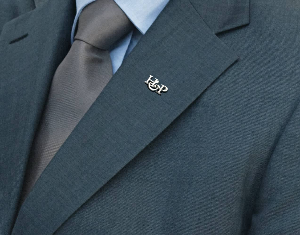 silver pin on suit