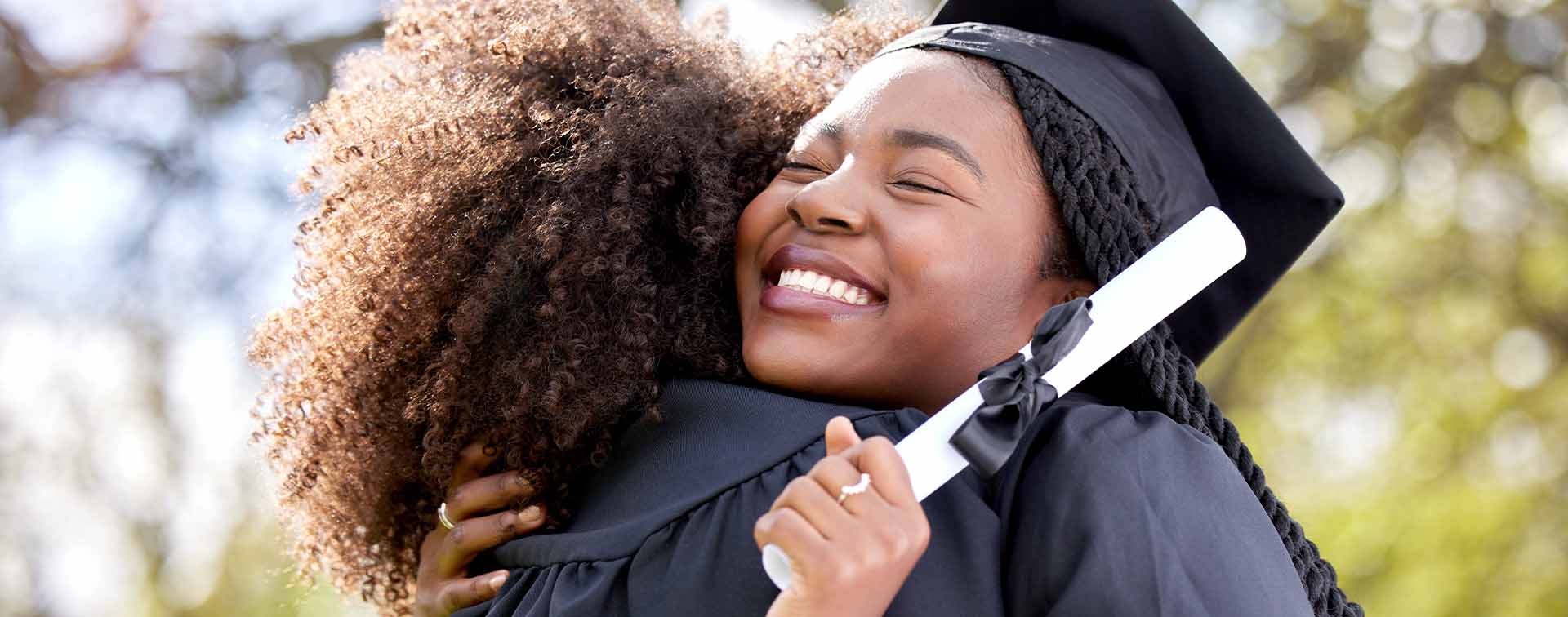 Two students hugging on graduation day