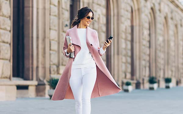 Smartly dressed woman in pink coat 