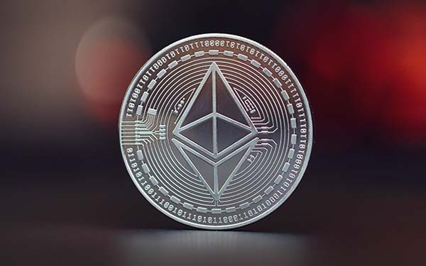 Close-up of silver colored Ethereum coin