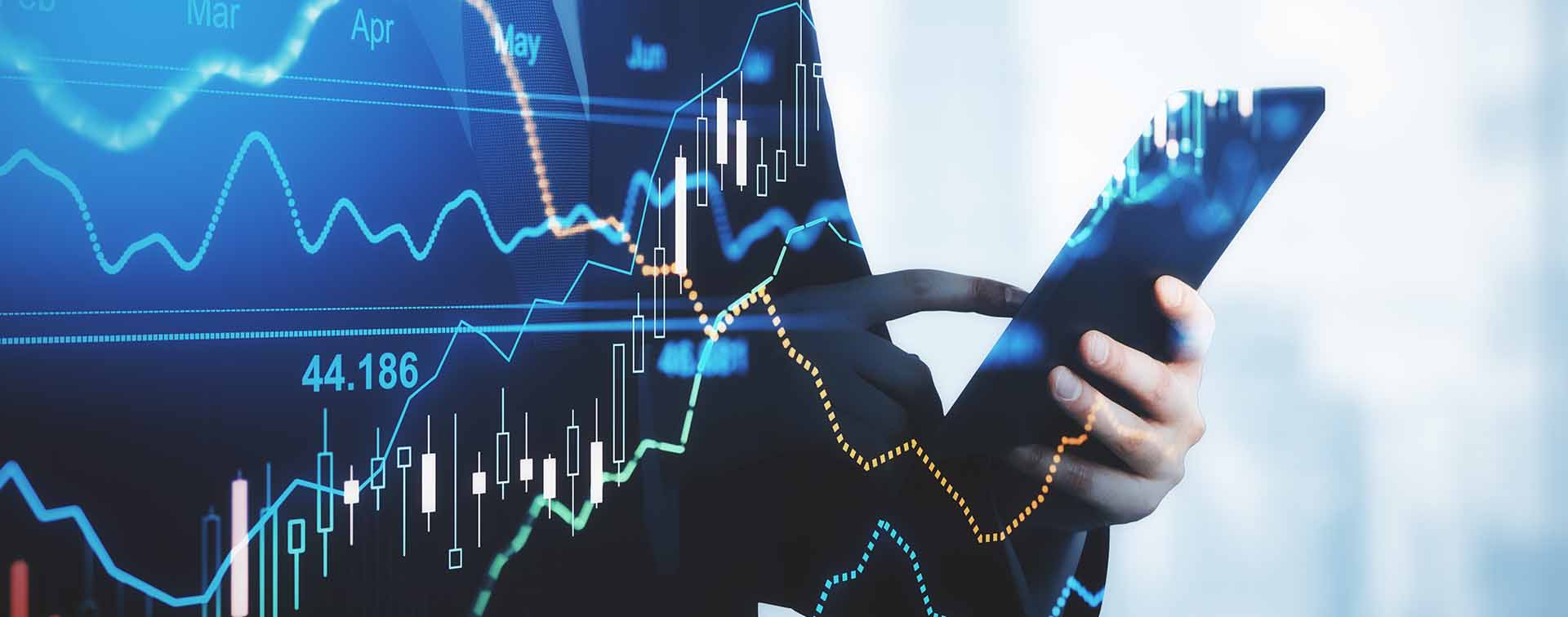- Trading and investment concept trader silhouette with digital tablet and virtual screen with financial chart graphs and candlestick