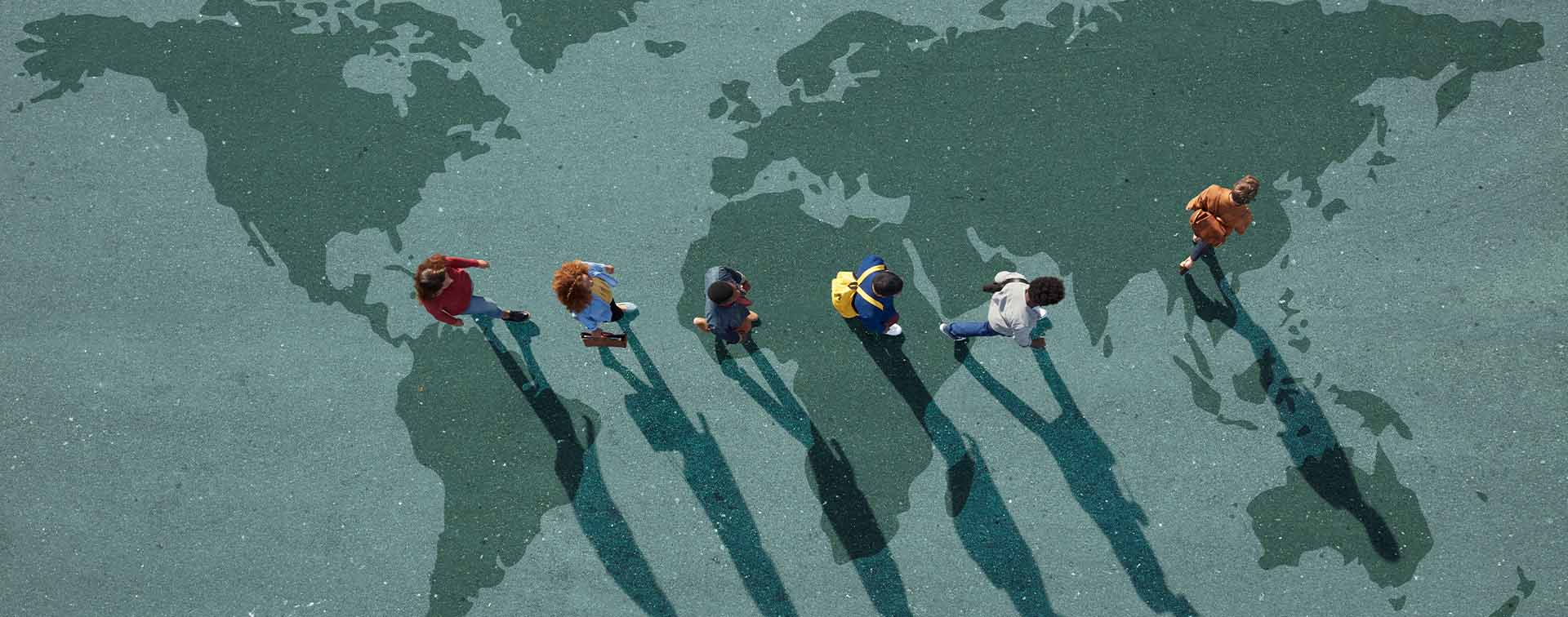 Diverse group standing on world map illustration representing global mobility