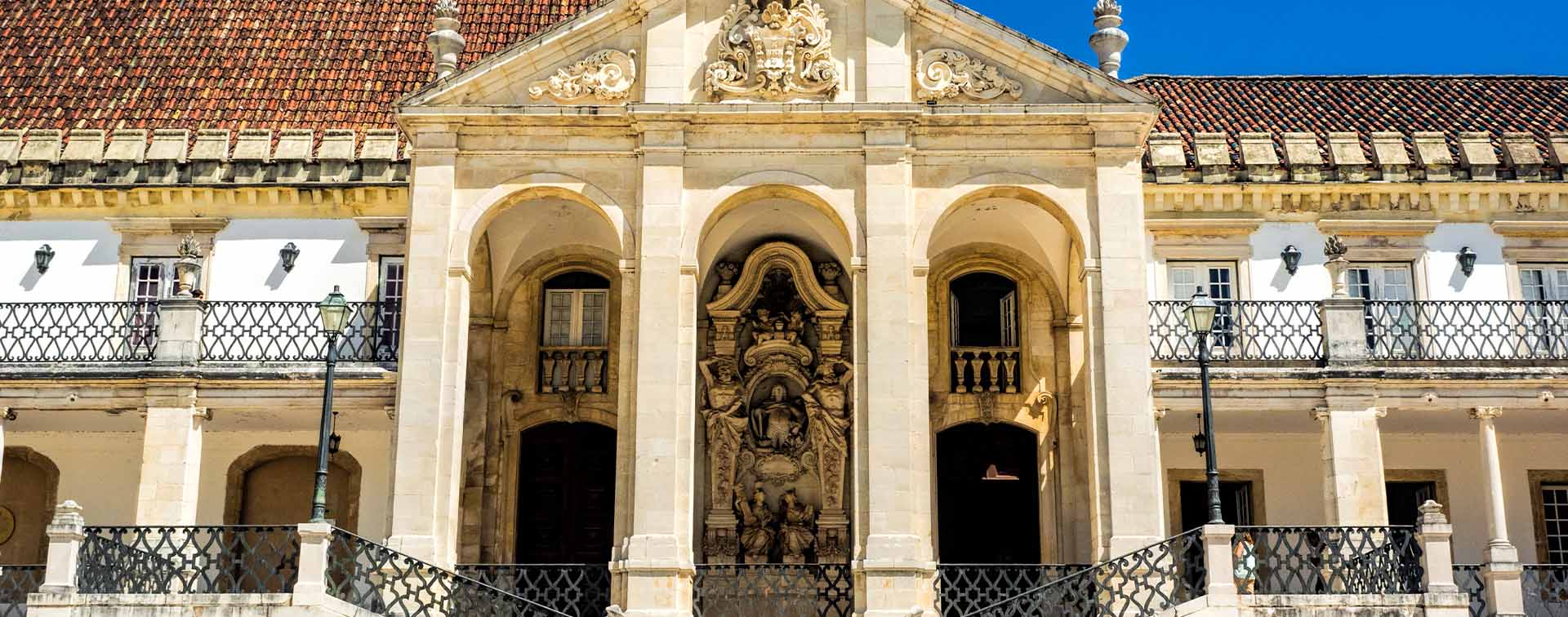 Historic university building with ornate architecture and tiled roof