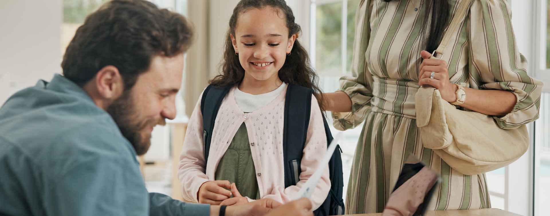 Parents helping young child prepare for school