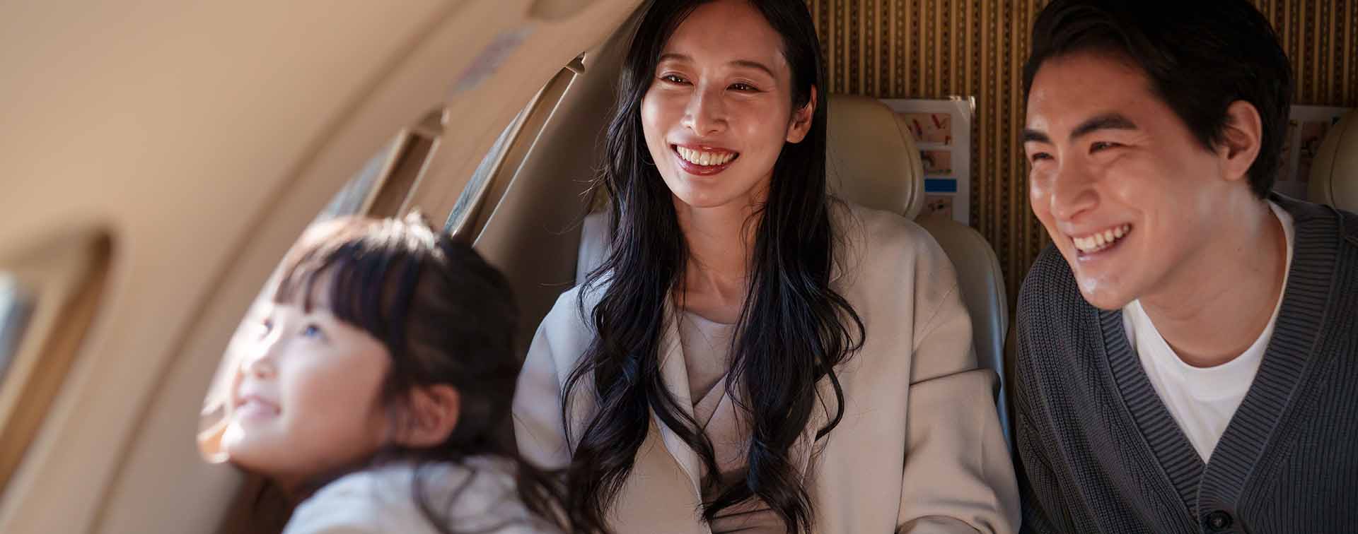 Family smiling together on an airplane