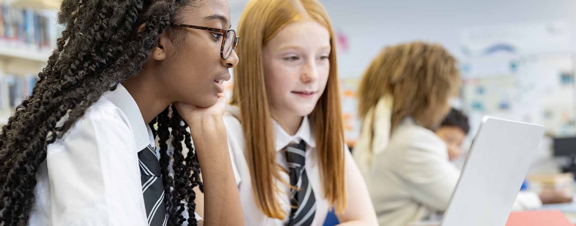 Teenage high school students studying in the school library