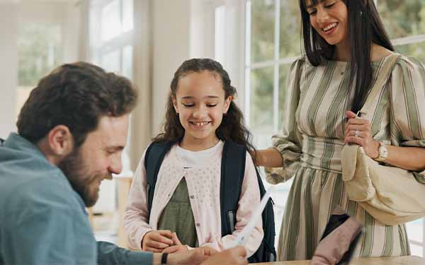 Parents helping young child prepare for school