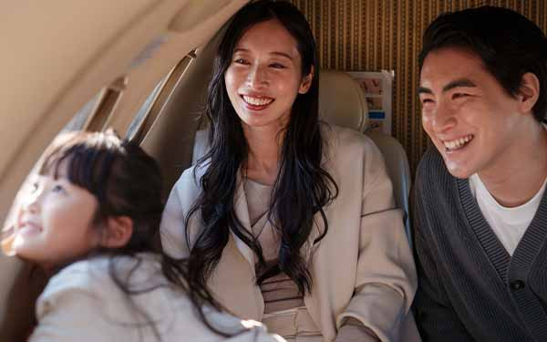 Family smiling together on an airplane