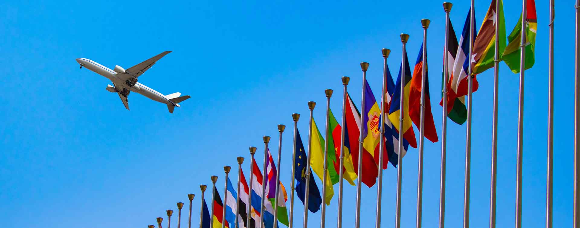 Flags of the world with aeroplane flying overhead