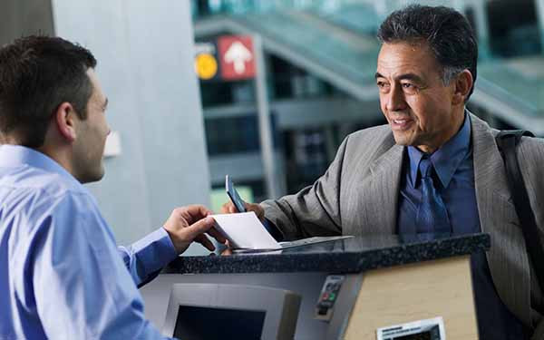 Man with passport at airport check-in desk