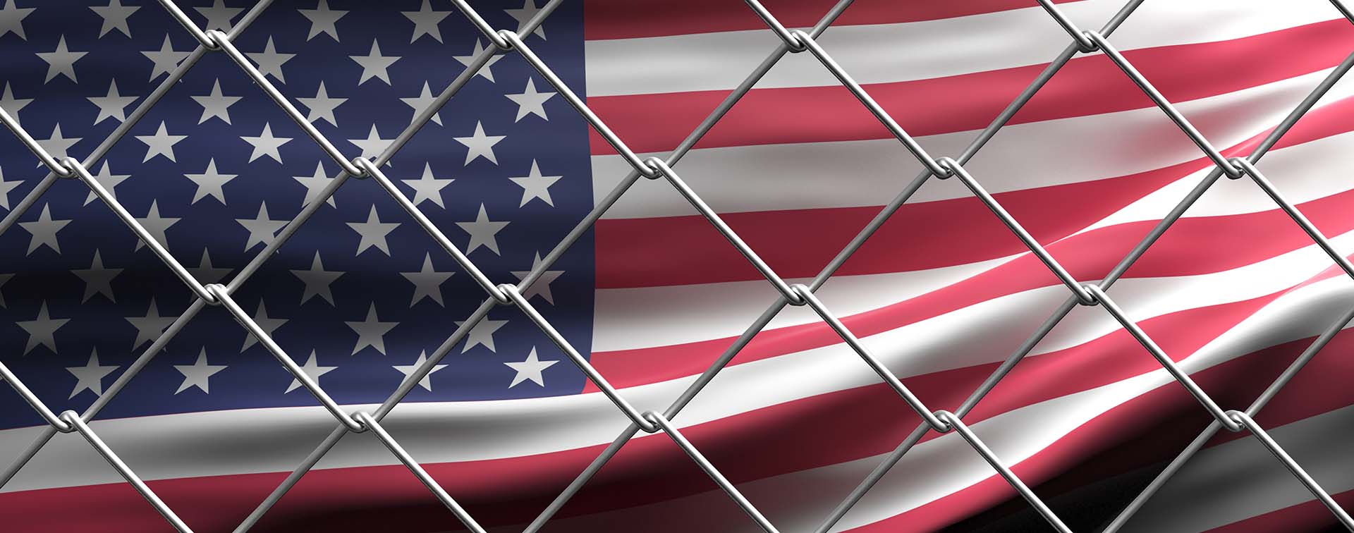 US flag behind wire mesh fence