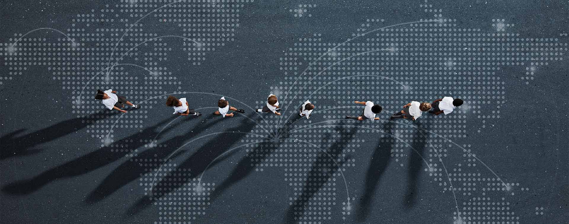 Abstract image of school children walking across a map of the world