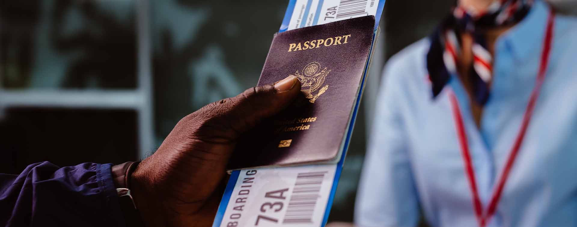 A person presenting their passport and boarding pass