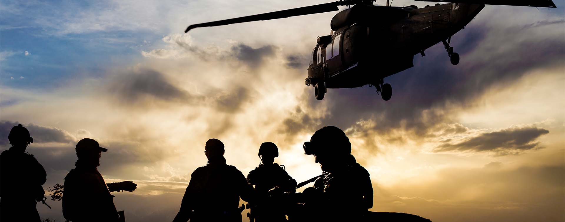 Silhouettes of soldiers during Military Mission at dusk