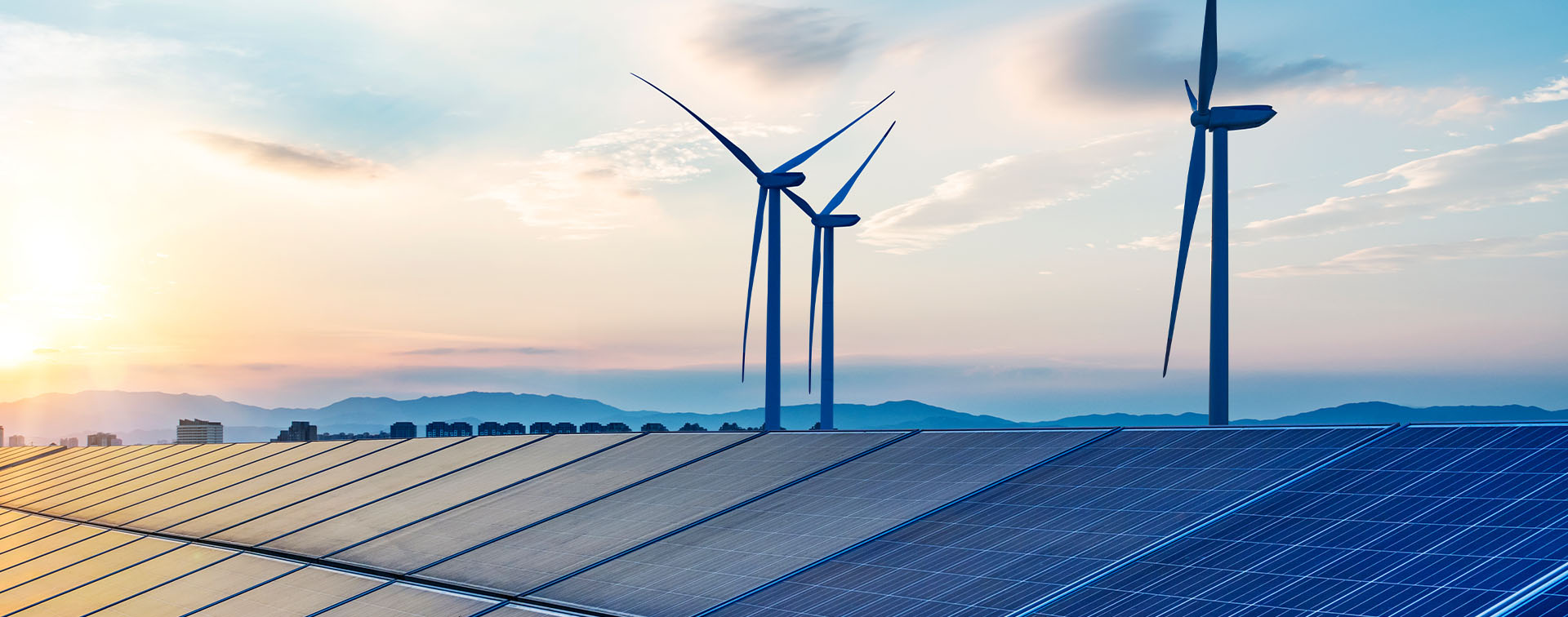 Wind turbines and solar panels under a blue sky