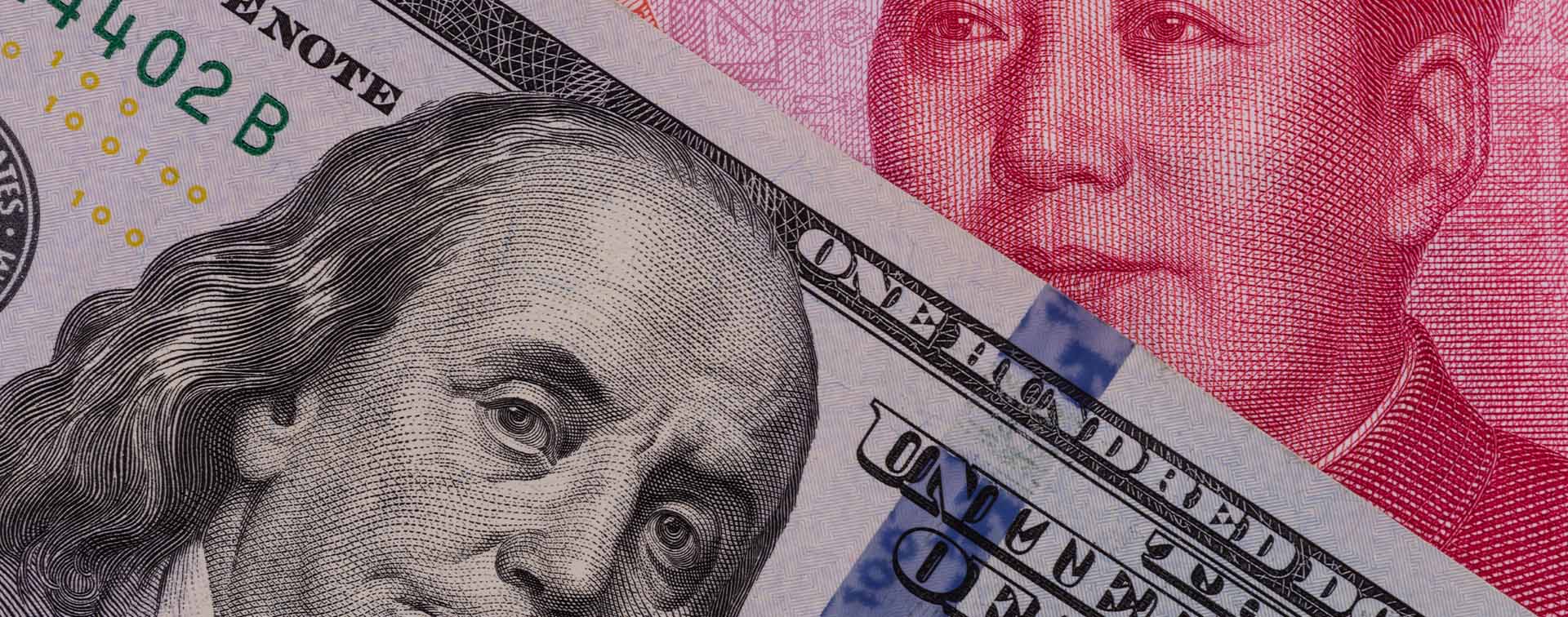 Close-up of US dollar and Chinese yuan banknotes