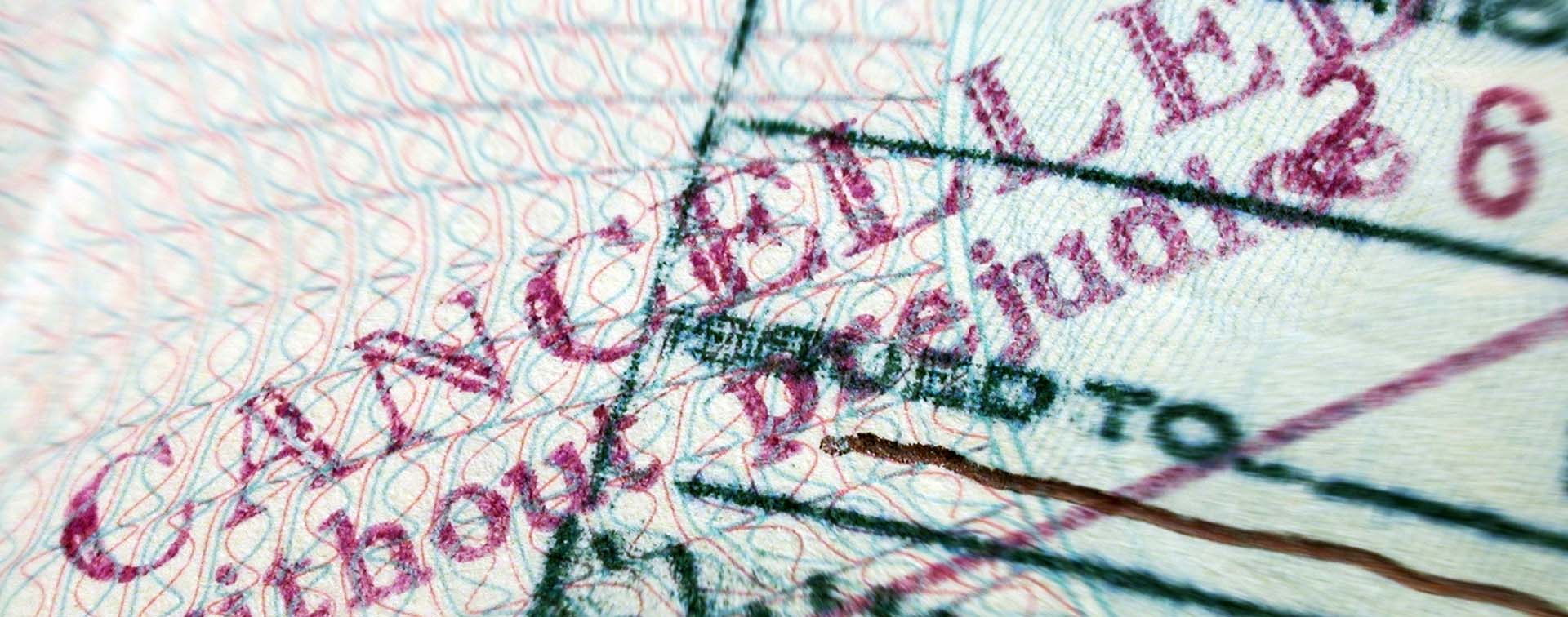 Close up of passport cancelled without prejudice stamp