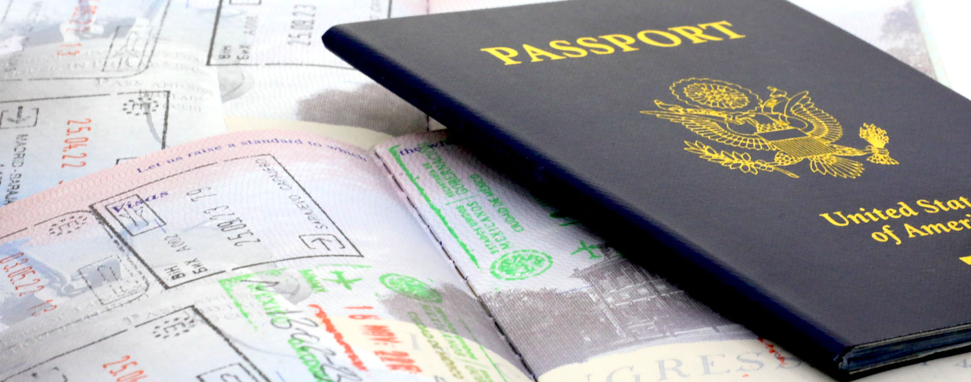 Passport resting on open pages with various visa stamps