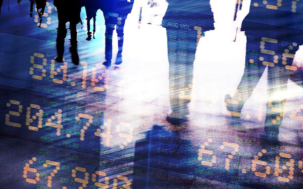 Blurred silhouettes of people overlaid with stock market data