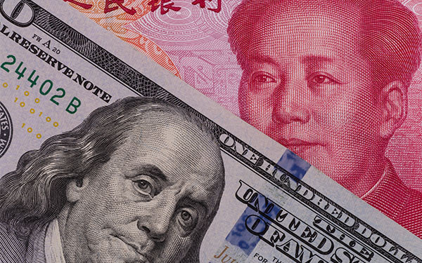 Close-up of US dollar and Chinese yuan banknotes