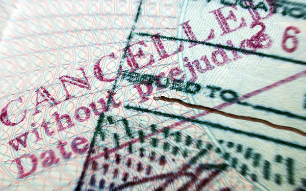 Close up of passport cancelled without prejudice stamp