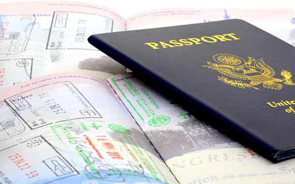 Passport resting on open pages with various visa stamps