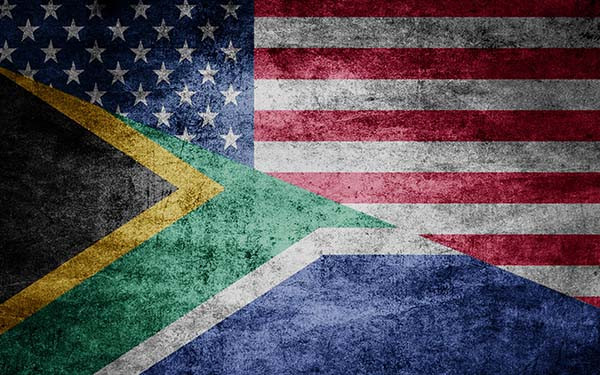 American and South African flags, rough relations. Flags on textured background