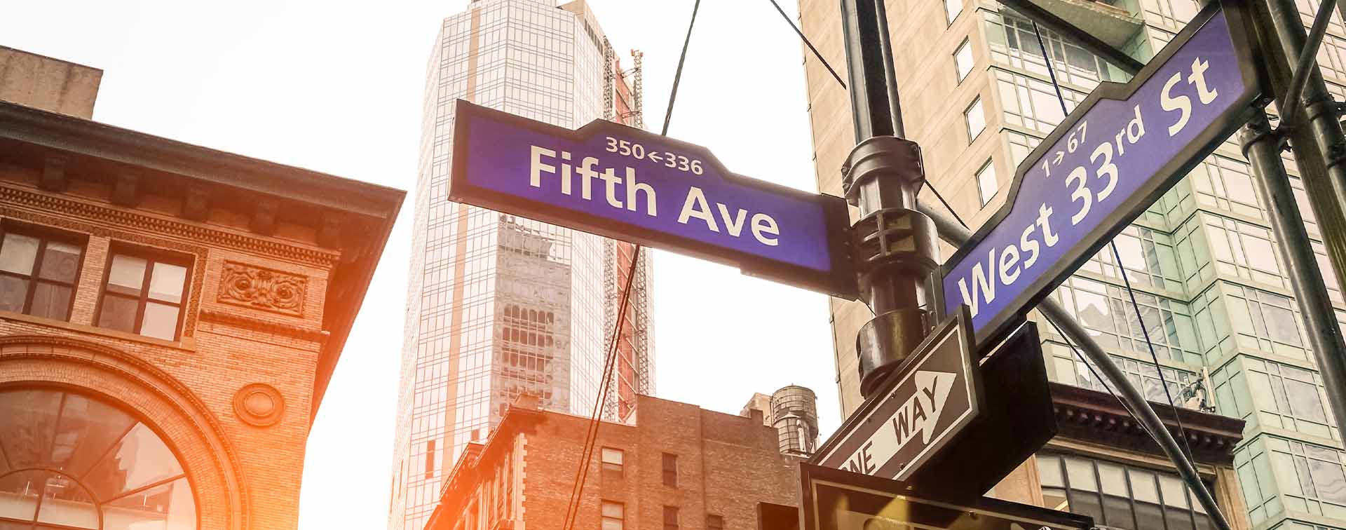Fifth Ave and West 33rd sign in New York City at sunset