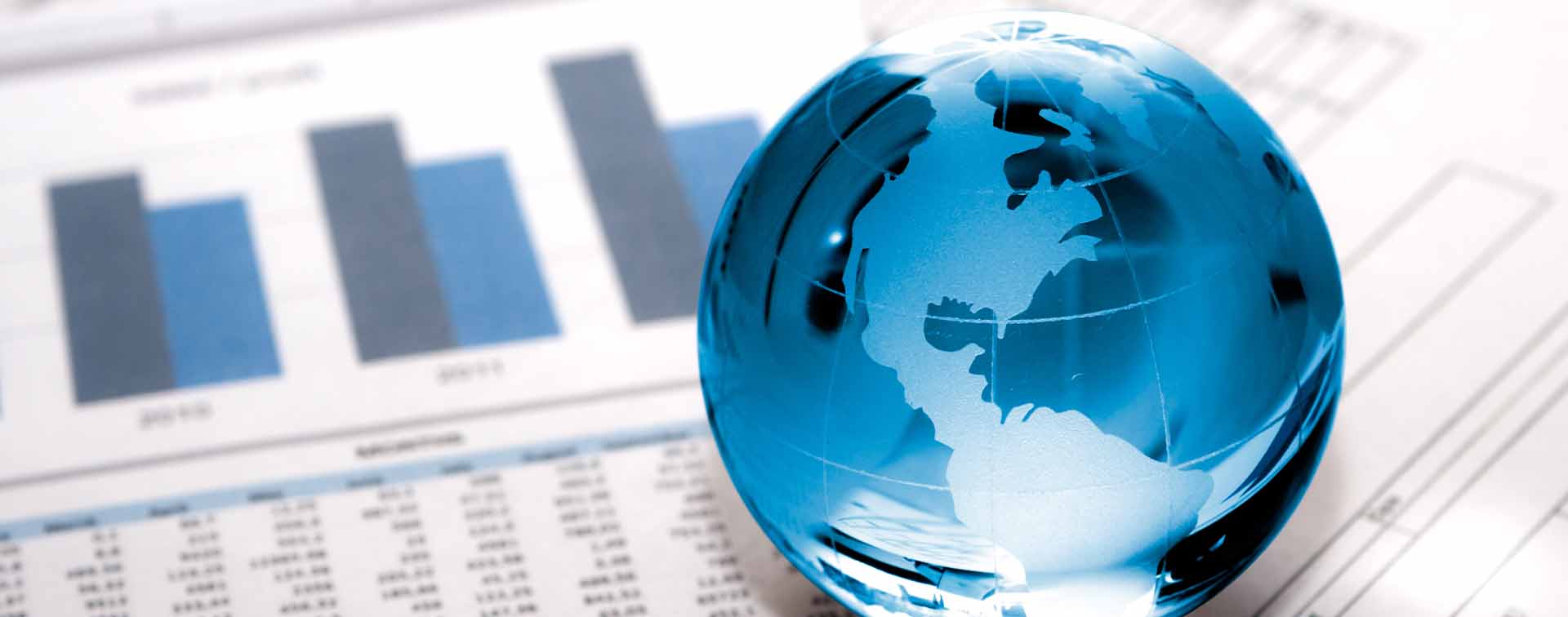 A glass globe on business papers