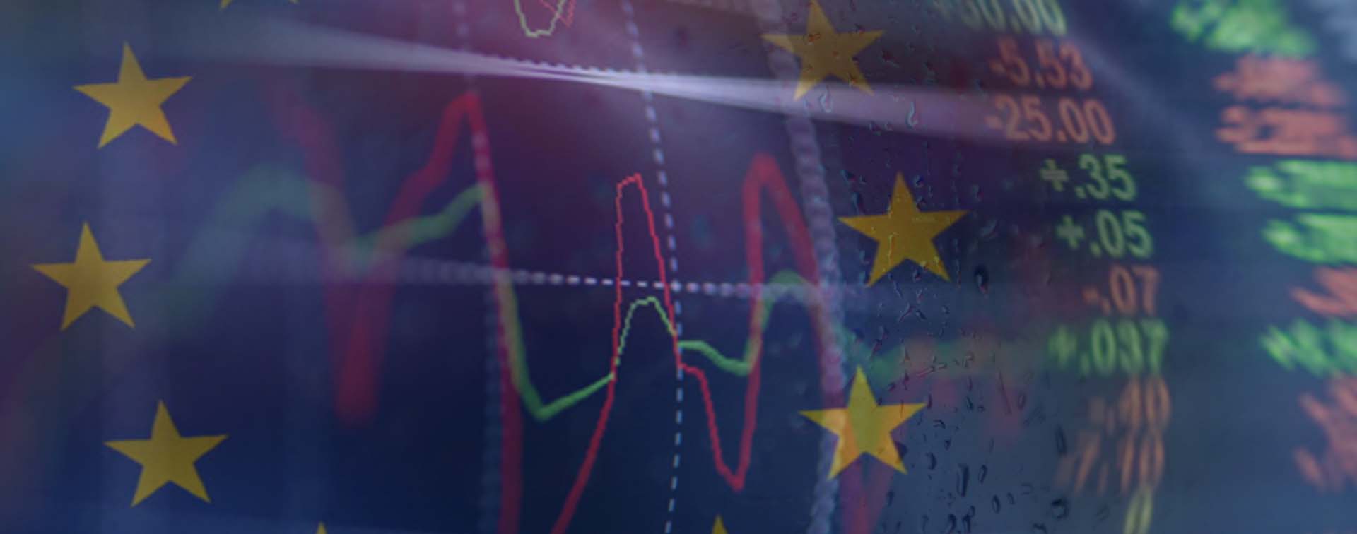 European Union flag with overlay of red and green stock market graphics. Europe, USA, World Economy, Wall Street and NY stock exchange have been under a lot of pressure