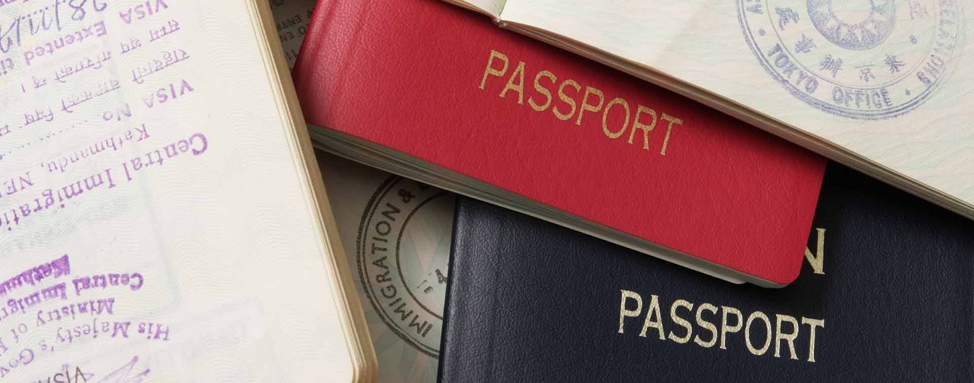 Many open spreads of passports overlaying each other
