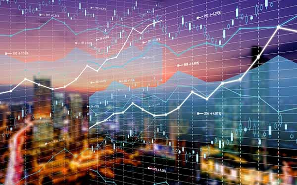 Double exposure business technology and abstract financial charts in sky on city background. Business information concept