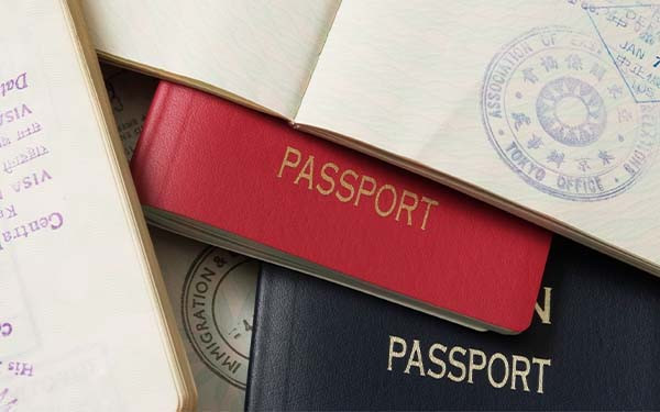 Many open spreads of passports overlaying each other