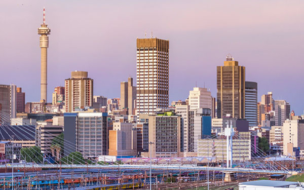Johannesburg city skyline with several tall buildings against a dusky sky