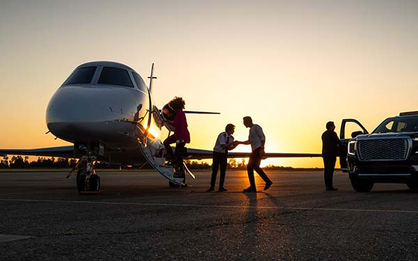 Pilot Welcoming Passengers onto Private Jet