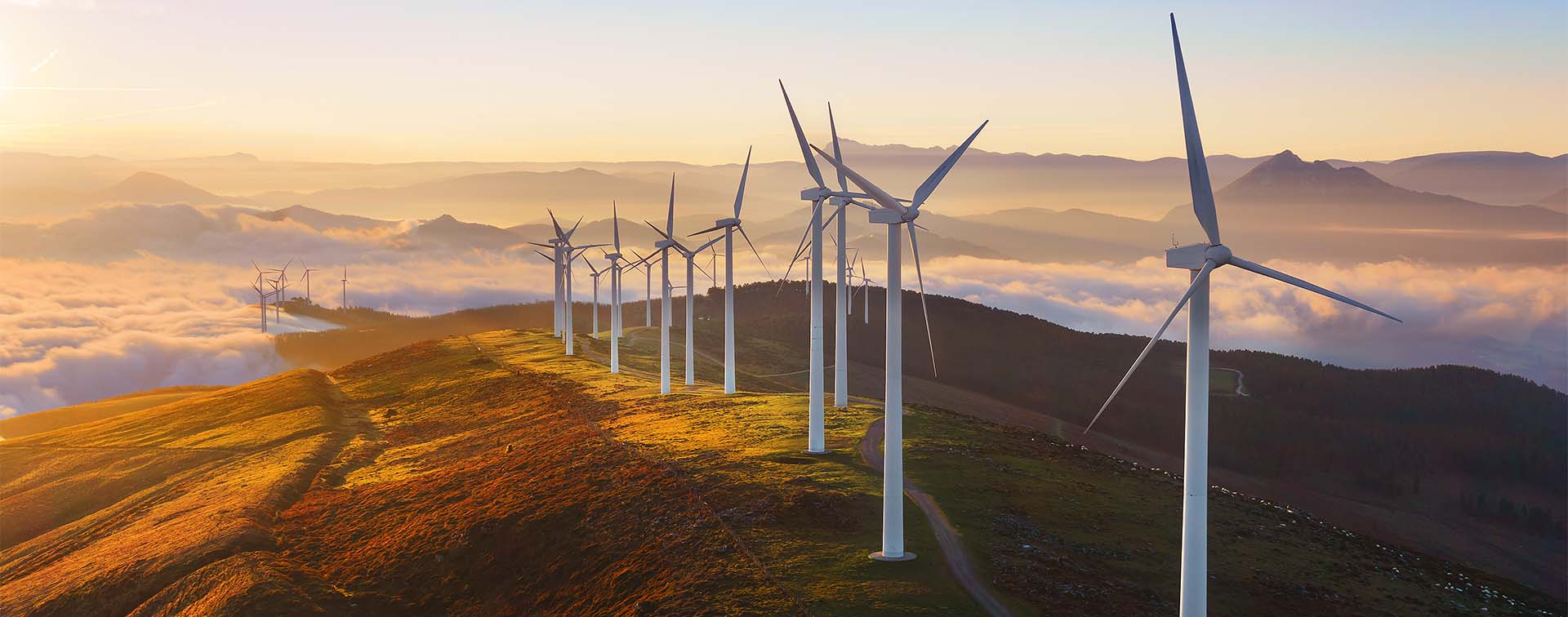 Wind turbines built on a hill in Biscay, Spain at sunset
