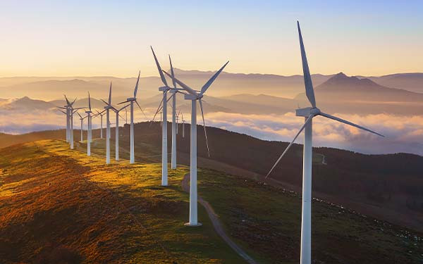 Wind turbines built on a hill in Biscay, Spain at sunset