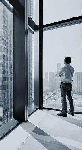 Businessman standing and looking at cityscape