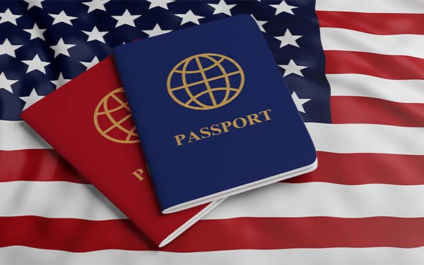 Two passports, one red one blue, on USA flag background. 3D illustration